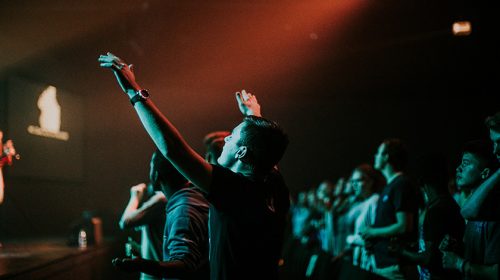 Group of people singing at a worship service