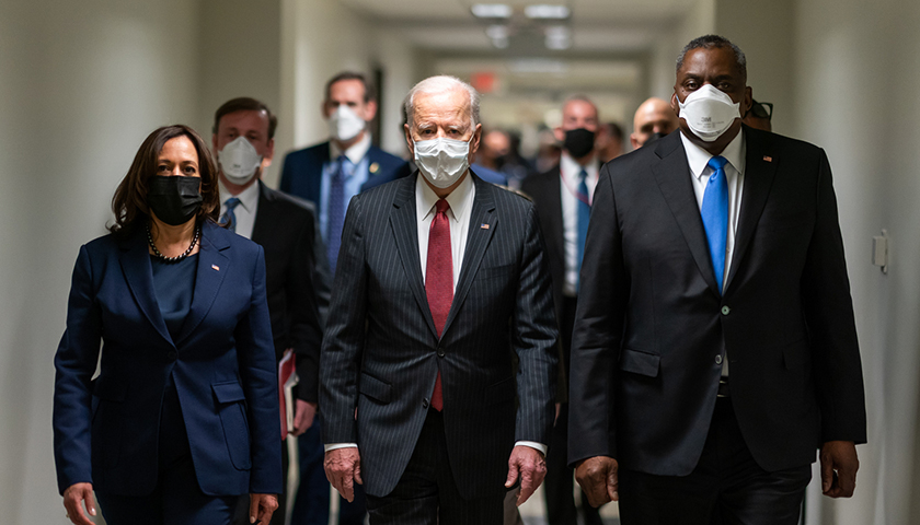 Joe Biden walking with his administration, wearing masks