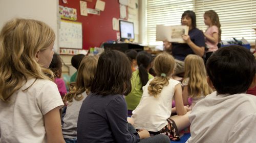 Classroom full of kids, that are being read a book