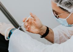 Doctor giving vaccination to patient
