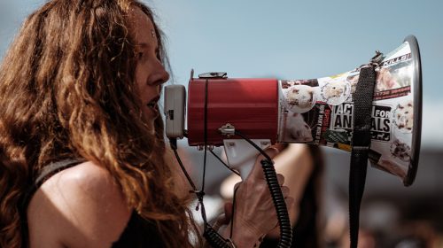 Protestor with megaphone, talking