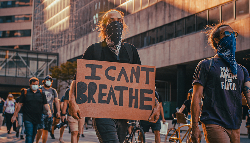 George Floyd protest in Minneapolis with "I can't breathe" cardboard sign