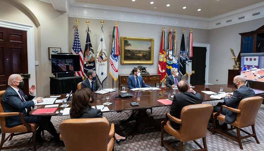 President Joe Biden and Vice President Kamala Harris, joined by White House staff, participate in a virtual bilateral meeting with Canadian Prime Minister Justin Trudeau on Tuesday, Feb. 23, 2021, in the Roosevelt Room of the White House. (Official White House Photo by Adam Schultz)