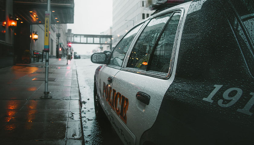 Side of police car while it's raining