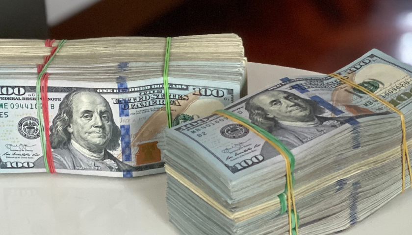 $100 bills in rubber bands