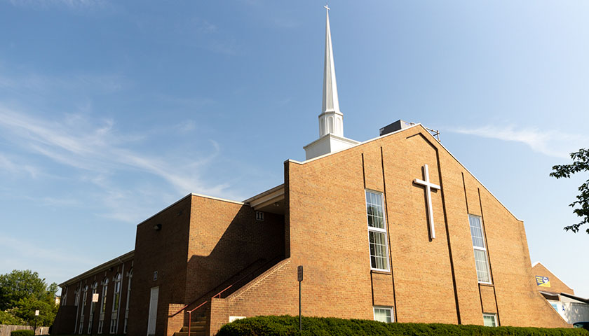 Shot of a brick church with blue sky