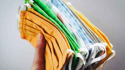 Someone holding a bunch of cloth masks