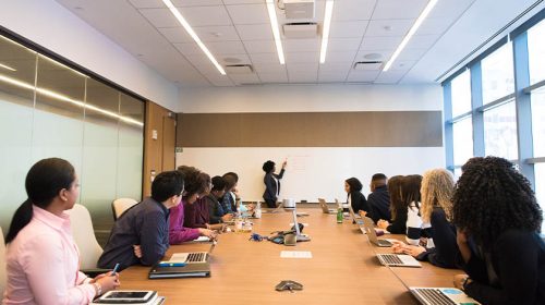 group of people in an office watching a presenter