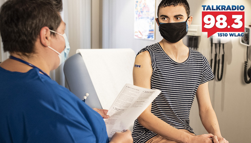 healthcare worker talking to patient after vaccination