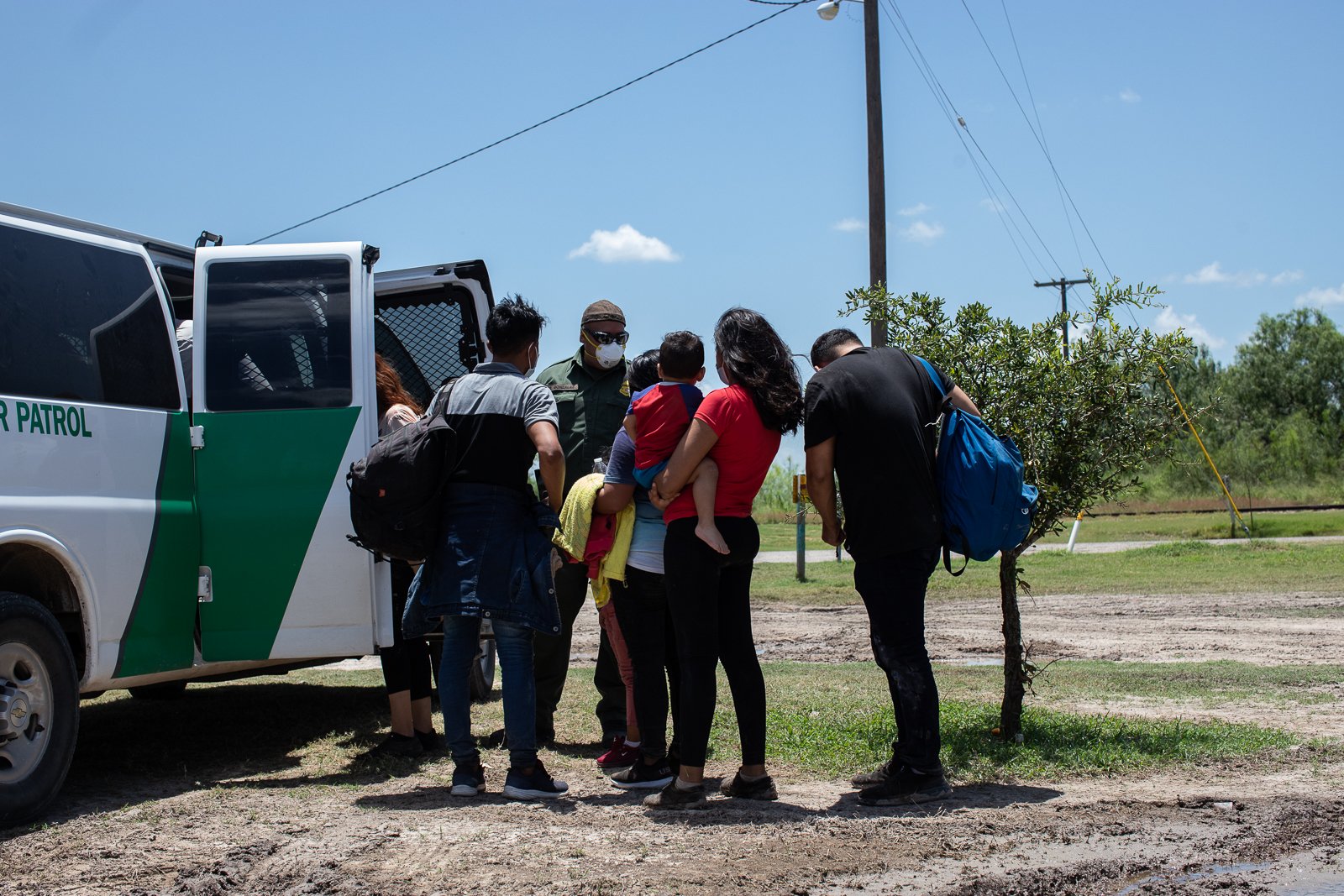 Migrants make their way to a Border Patrol transport vehicle after illegally entering the U.S. near ​La Joya, Texas, on August 7, 2021. (Kaylee Greenlee – Daily Caller News Foundation)