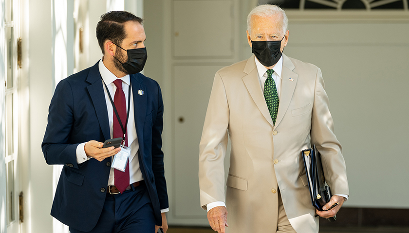 President Joe Biden and Personal Aide Stephen Goepfert walk through the Colonnade, Friday, August 6, 2021, on the way to the Oval Office of the White House. (Official White House Photo by Adam Schultz)