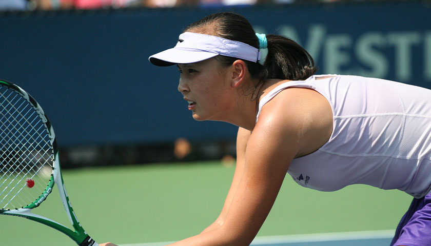 Peng Shuai with tennis racket in hand