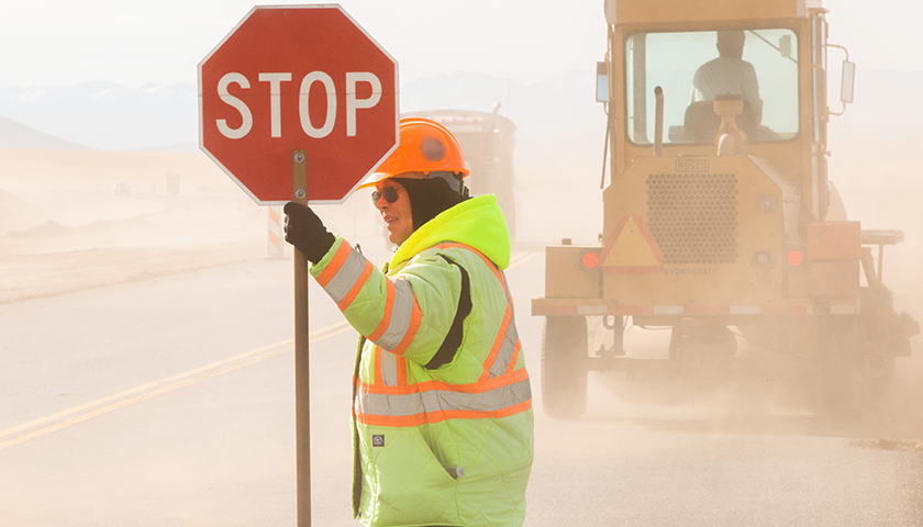 construction worker holding a stop sign