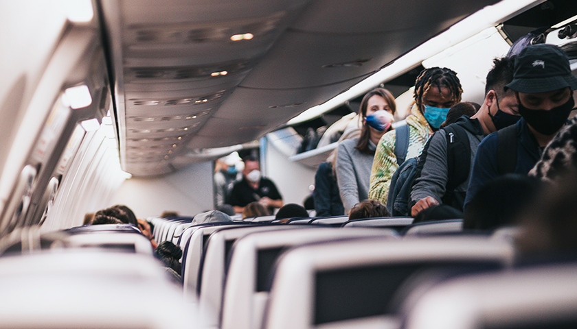 People in an airplane with masks on