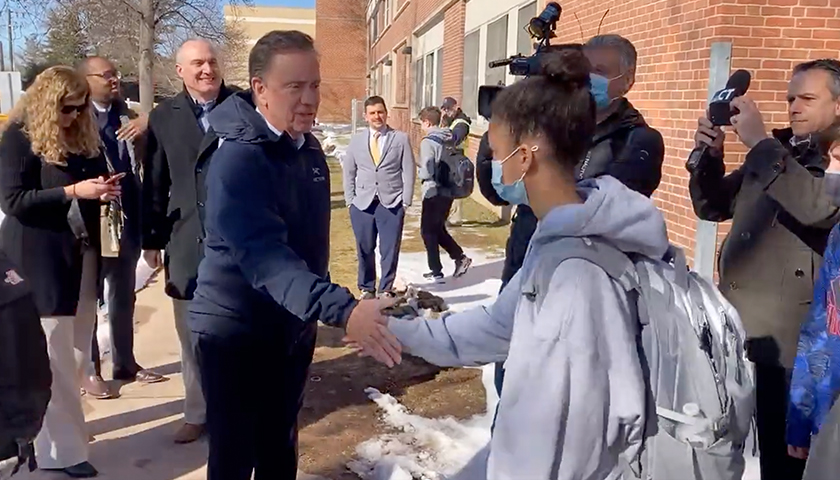 Ned Lamont shaking hands with students during school visit