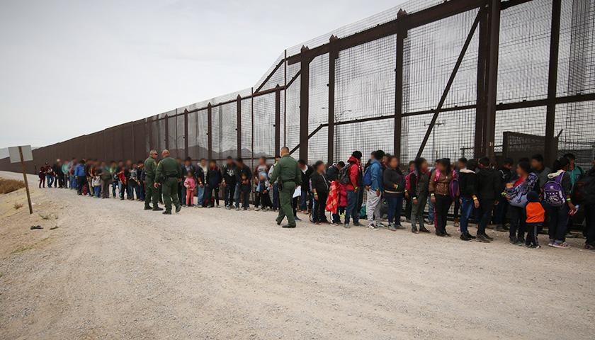 Illegal migrants at a border fence