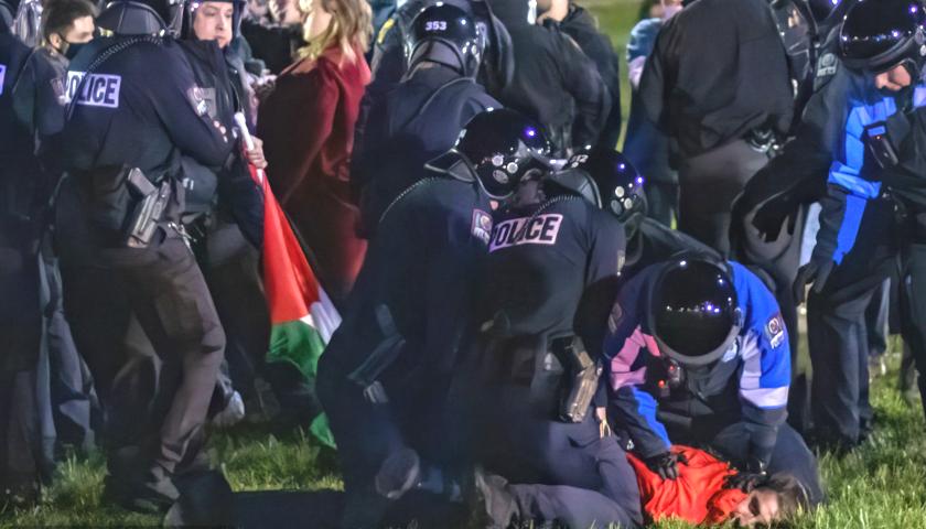 Police arresting campus protester