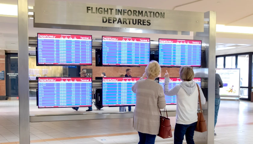 People checking departing flights