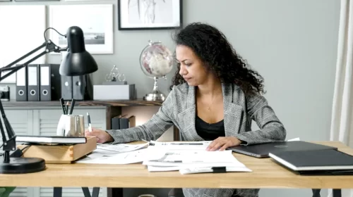 Woman doing paperwork at her desk