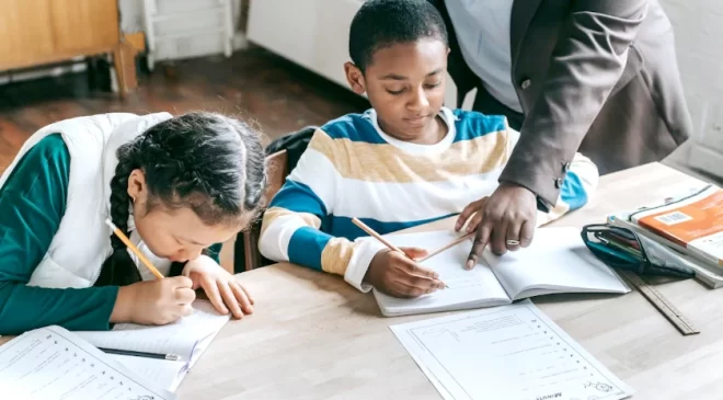 Tutor helping kids study