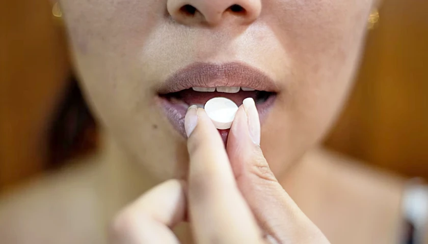 woman taking pill